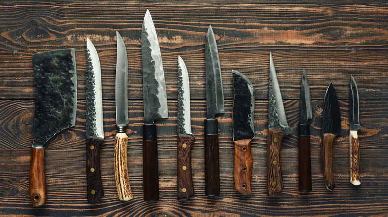 Set of kitchen knives on a dark wood table or countertop