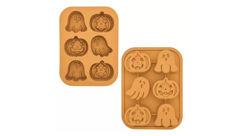 Two orange cakelet pans with ghost and jack-o'-lantern molds