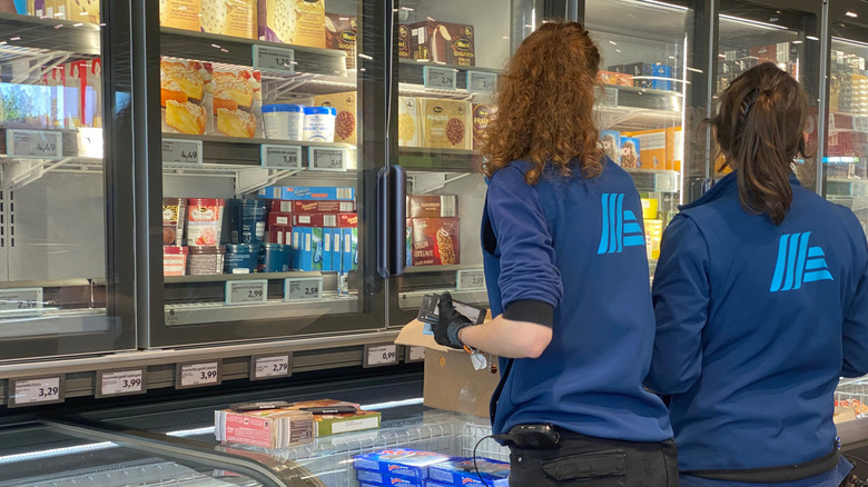 Aldi workers restocking