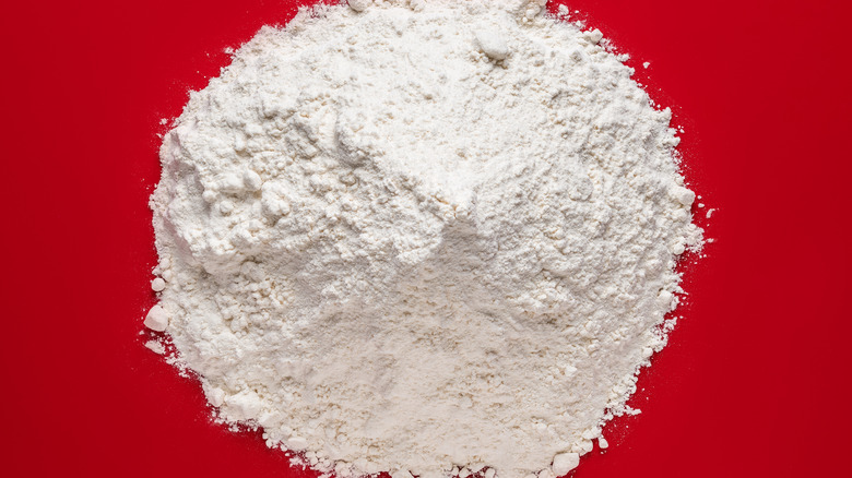 a pile of AP flour on a red cutting board