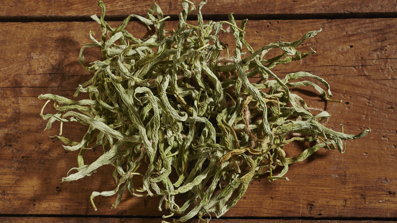 Dried string beans, called leather britches or shucky beans, against a wooden background