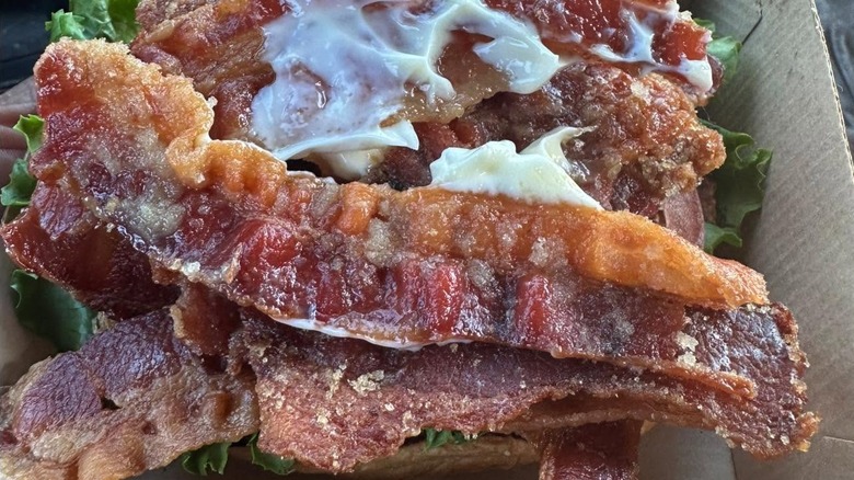2 Bacon Beef 'n Cheddars from Arby's side by side on red and white background