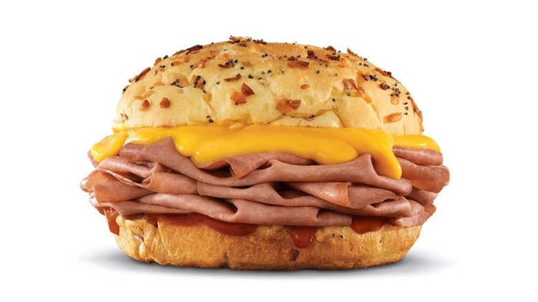Beef 'n Cheddar on an onion roll on white background