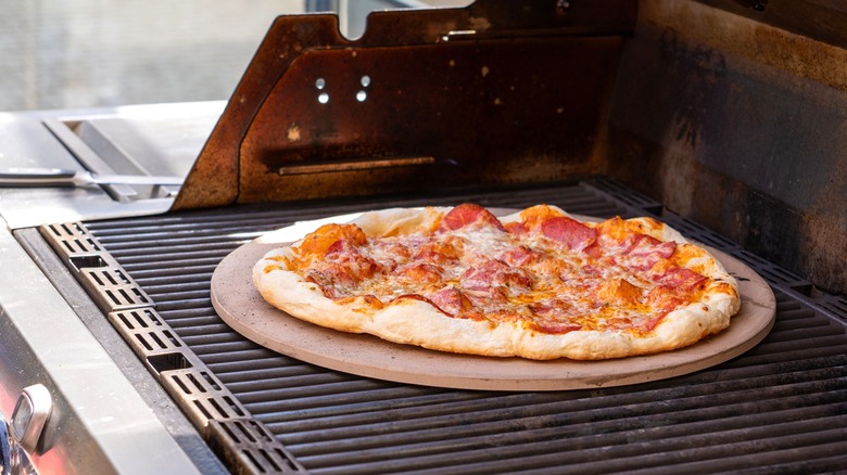 Pizza on pizza stone in home oven