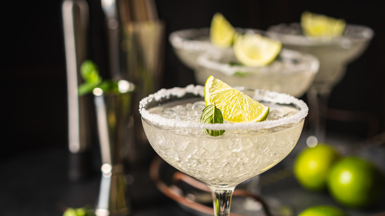 Margarita cocktails in glasses, lined up on a countertop