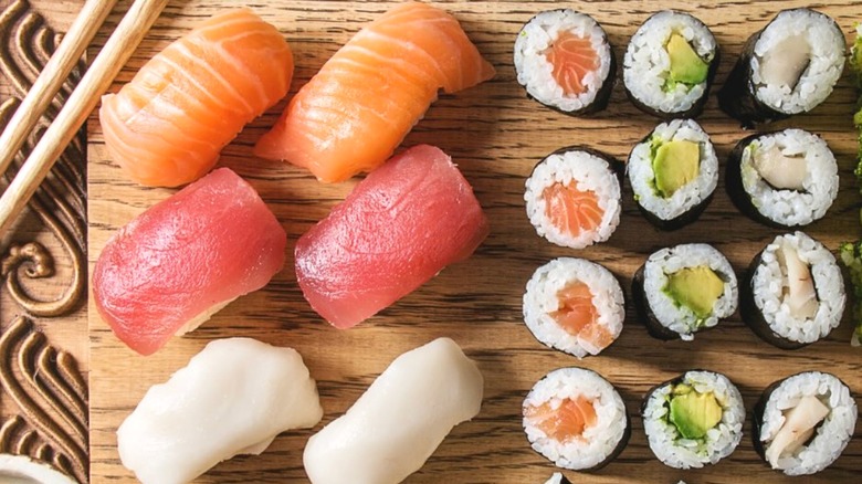 Sushi rolls and pieces on wooden plate from Kikoo