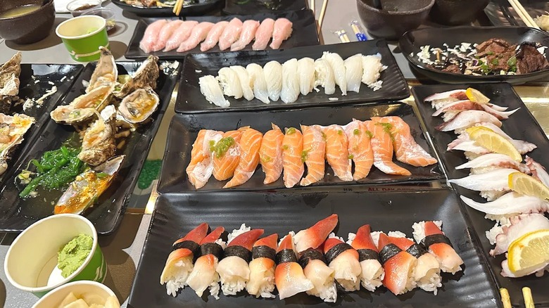 Vast array of sushi plates on table at Sushi Neko