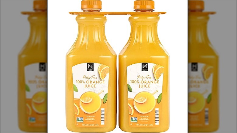 Two bottles of fresh orange juice, with the words Pulp Free 100% Orange Juice on the label