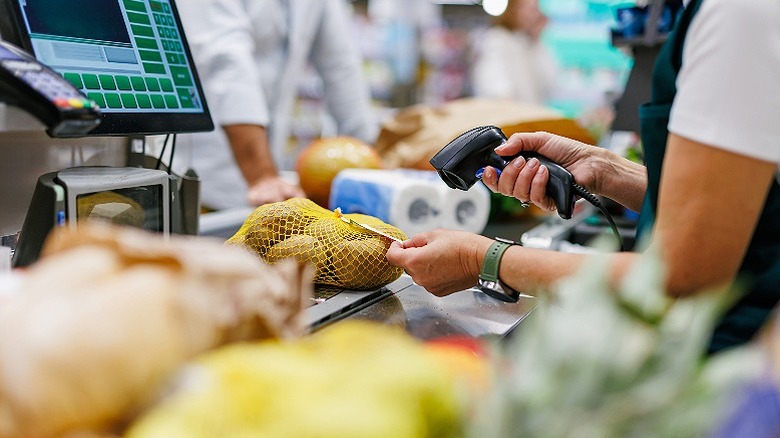 supermarket cashier scanning product