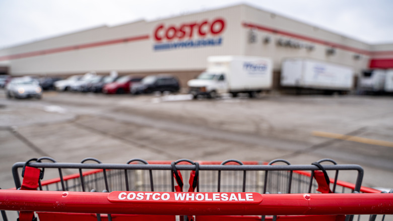 Costco cart in front of Costco warehouse