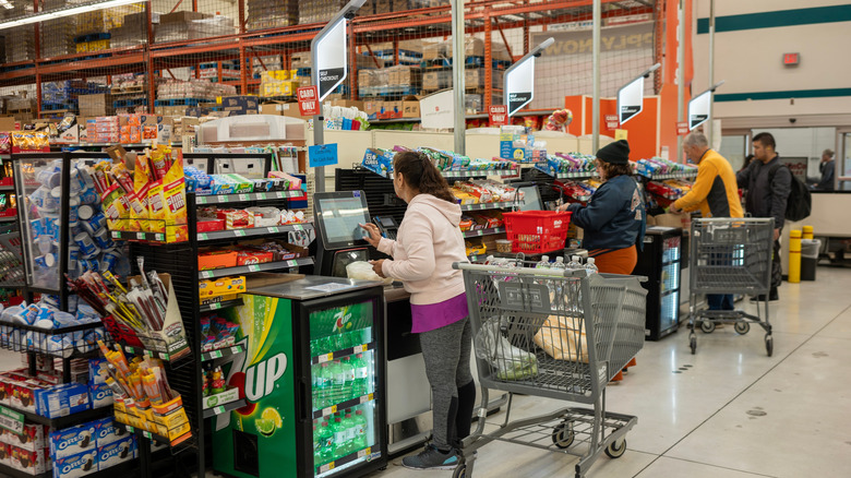 Customers checking out at self checkout in WinCo
