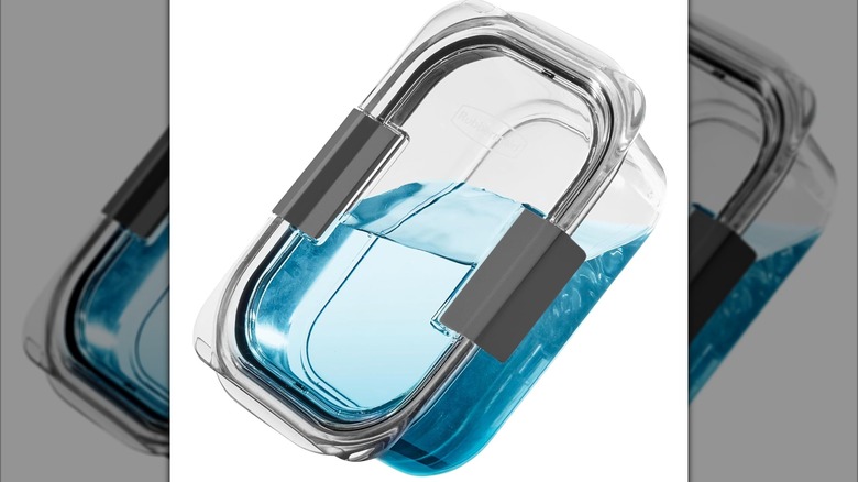A Rubbermaid Brilliance Plastic Food Storage Container, with liquid inside, showing its leakproof nature
