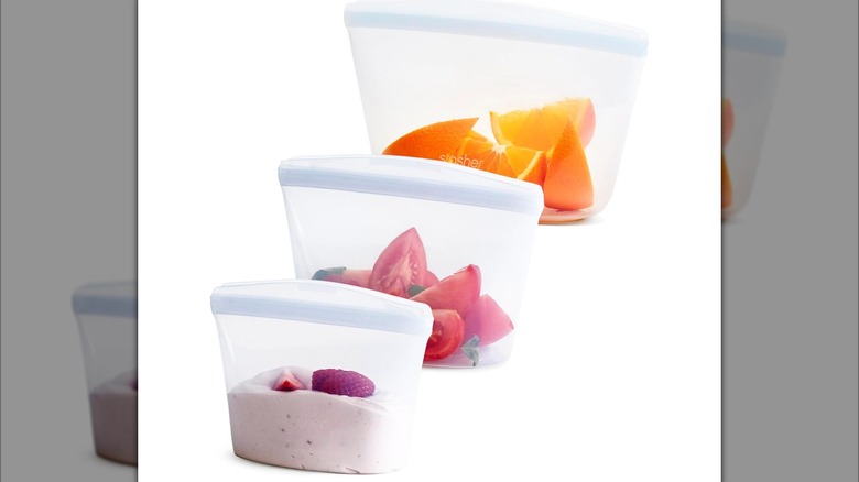 Stasher Premium Silicone Reusable Food Storage Bags with food inside on a white background