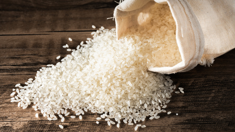 White rice spills from a sack