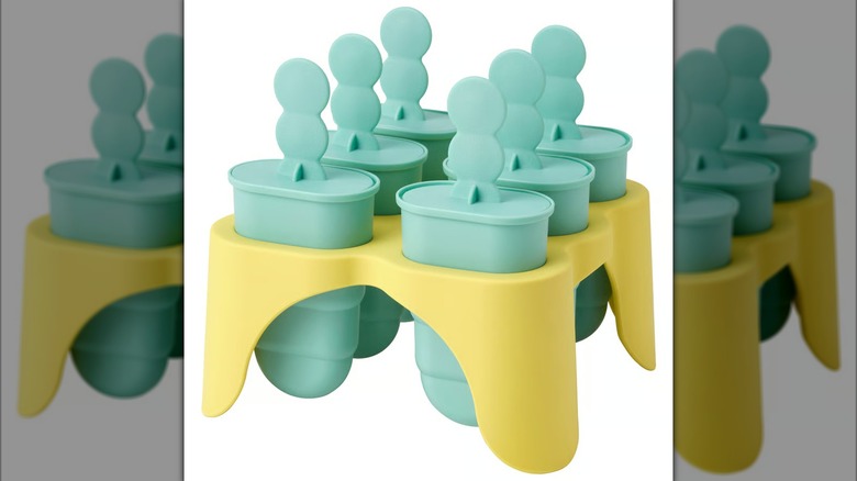 Six turquoise ice pop molds in yellow stand