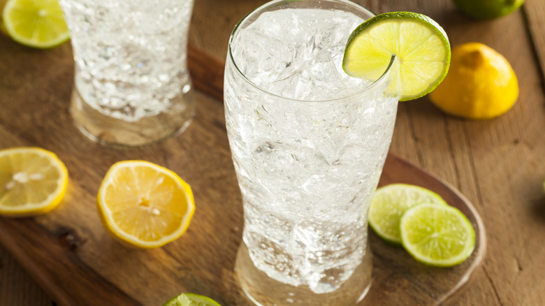 A glass of lemon-lime soda garnished with a lime wheel