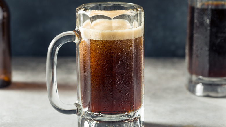 A glass mug of root beer soda