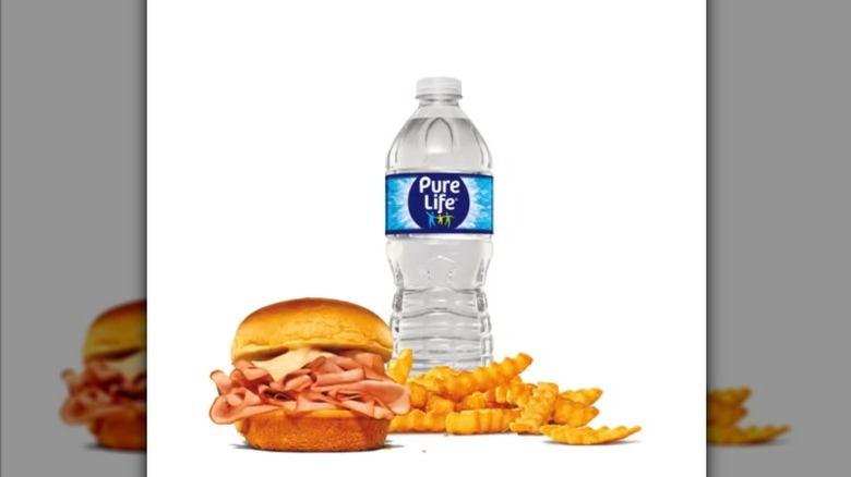 A ham and cheese slider and crinkle-cut fries from Arby's, with a Pure Life bottle of water to drink, against a white background