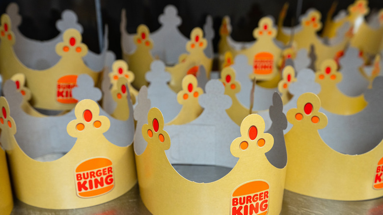 A group of paper monarch's crowns from Burger King, set out on a counter