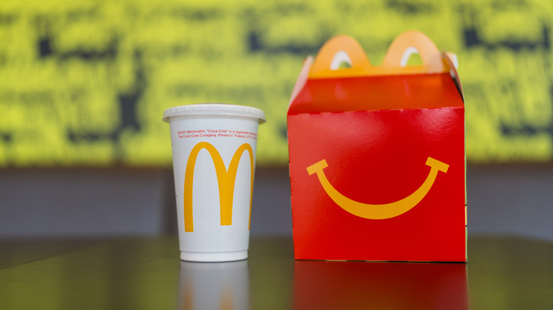 A Happy Meal box and drink cup from McDonald's on a table
