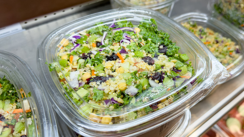 Grain and celery salad in a clear plastic package on a shelf at Costco