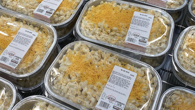 Costco mac and cheese in an aluminum package on a wire rack at the store