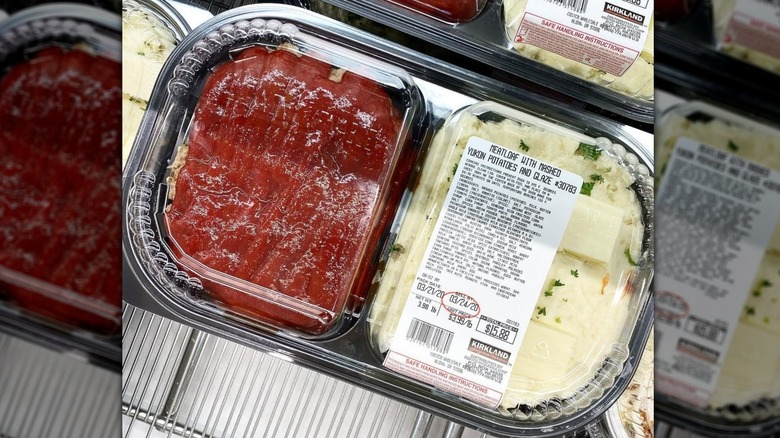 Meat loaf and mashed potatoes from Costco in a black plastic container on a shelf at the store