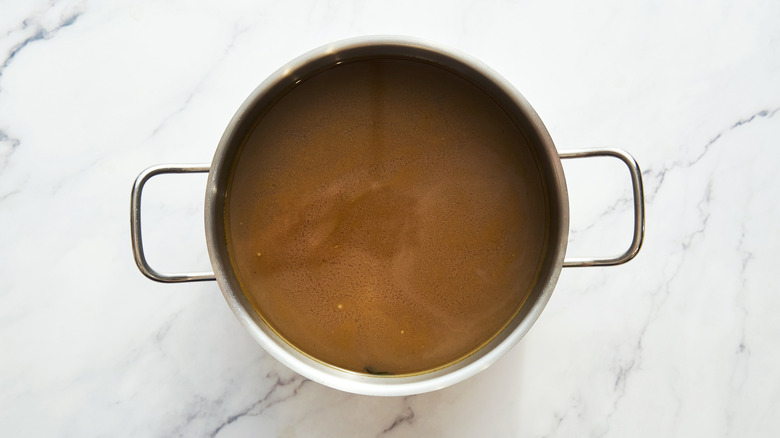 An overhead view of a pot of stock