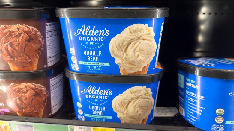 tubs of alden's organic vanilla bean ice cream on freezer aisle shelf in a grocery store