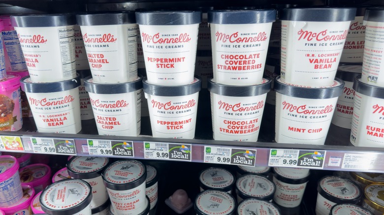 mcconnell's ice cream pints stacked in a grocery store freezer display case