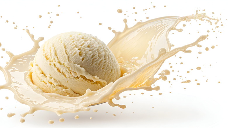 scoop of vanilla ice cream stylized against white background, splashing into cream