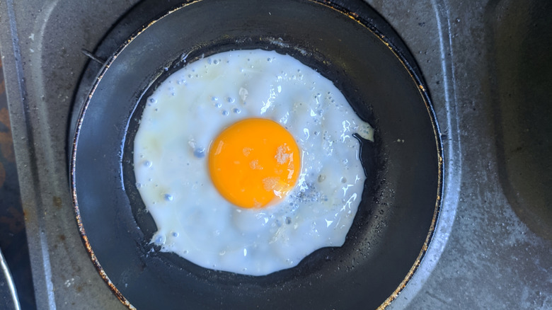 sunny side up egg cooking in skillet
