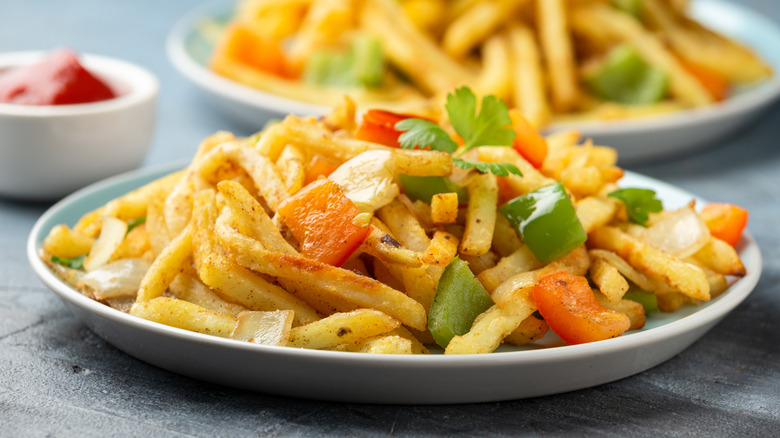 A plate full of salt and pepper chips on a table