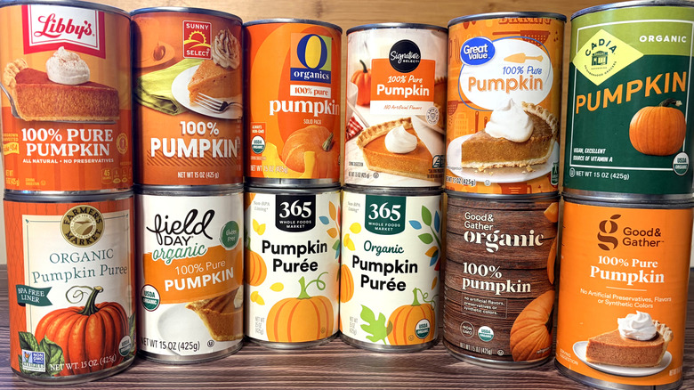 cans of various brands of pumpkin stacked in two rows on table