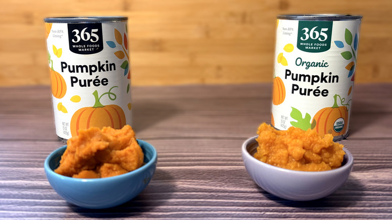 Two cans and small bowls of Whole Foods Market 365 organic and regular pumpkin purée
