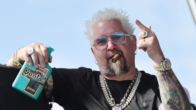 Guy Fieri with a cigar and tequilla