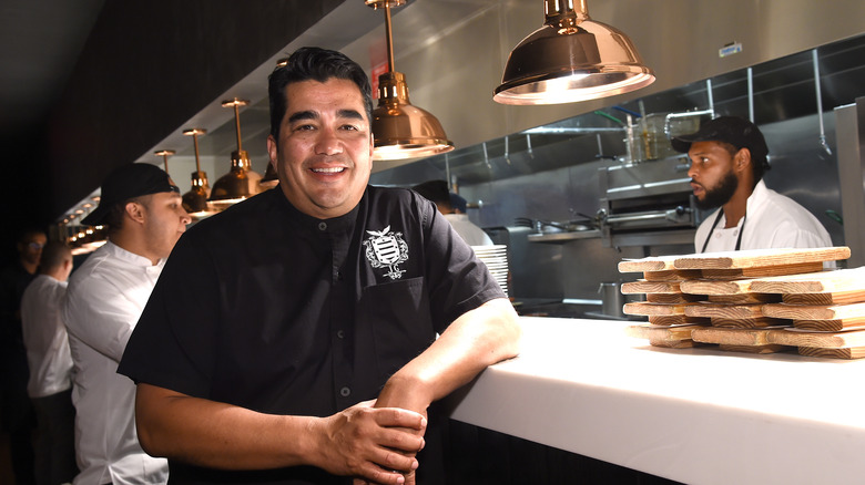 Jose Garces in a kitchen expo window