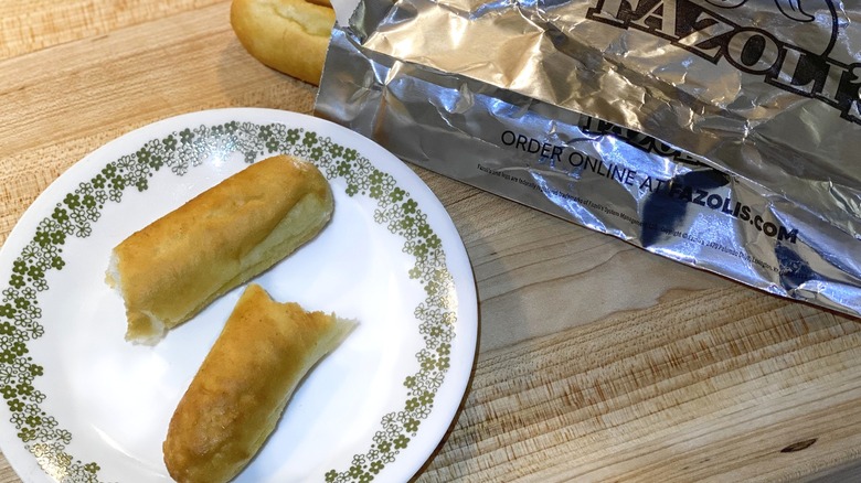 Fazoli's breadstick bag next to breadsticks on plate