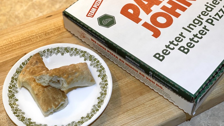 Papa John's box next to a plate of breadsticks
