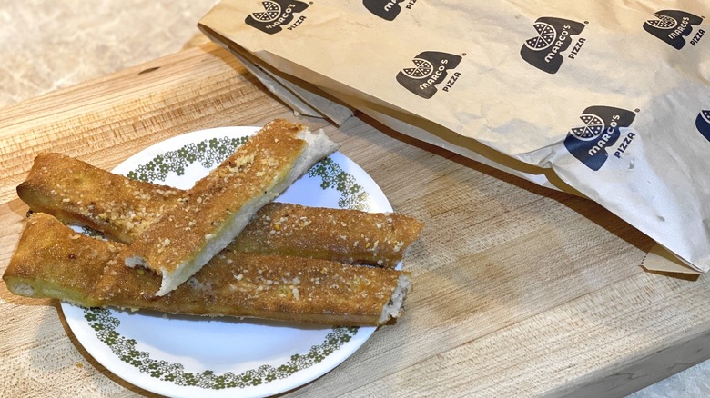 Marco's breadstick bag next to a plate of breadsticks