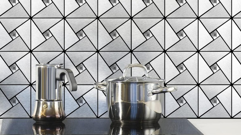 Art3d peel-and-stick metal tile design behind a stovetop in kitchen