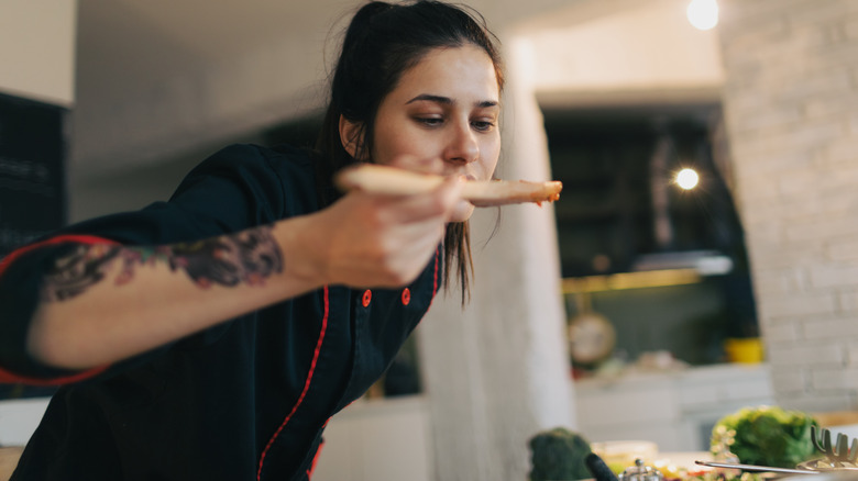 Chef tasting pasta sauce