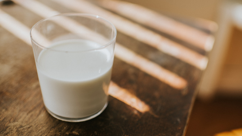 Glass of milk on wooden table