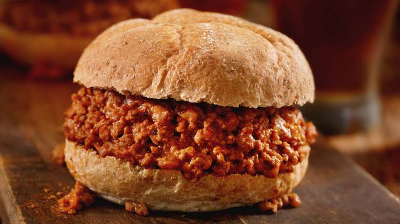 A Sloppy Joe sandwich on a wooden surface