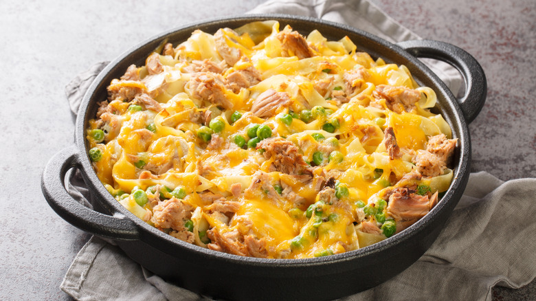 cheesy tuna noodle casserole in a cast iron pan