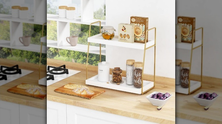White and gold countertop organizer on a butcher block kitchen counter and white background