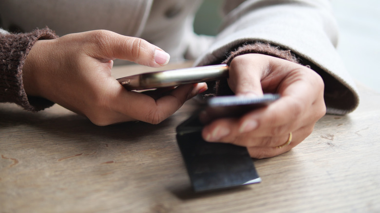 A close-up of hands as someone scans a QR code menu