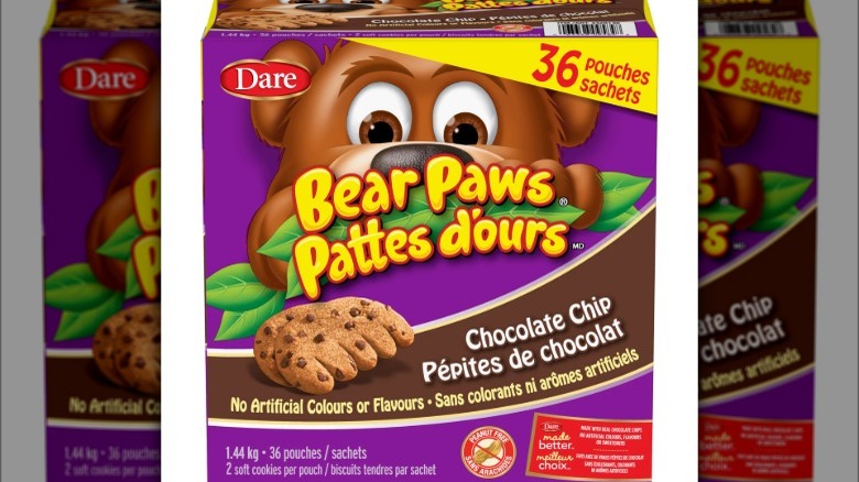 A purple box with the words Bear Paws Pattes D'Ours and a cartoon of bear and a chocolate chip cookie