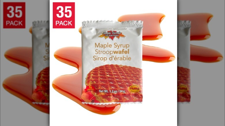 A 35 pack of Maple Syrup Stroopwafel with splashes of maple syrup in the backgound