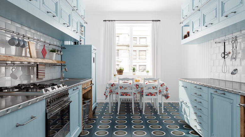 A bright retro kitchen with bold tile floors and sky blue cabinets